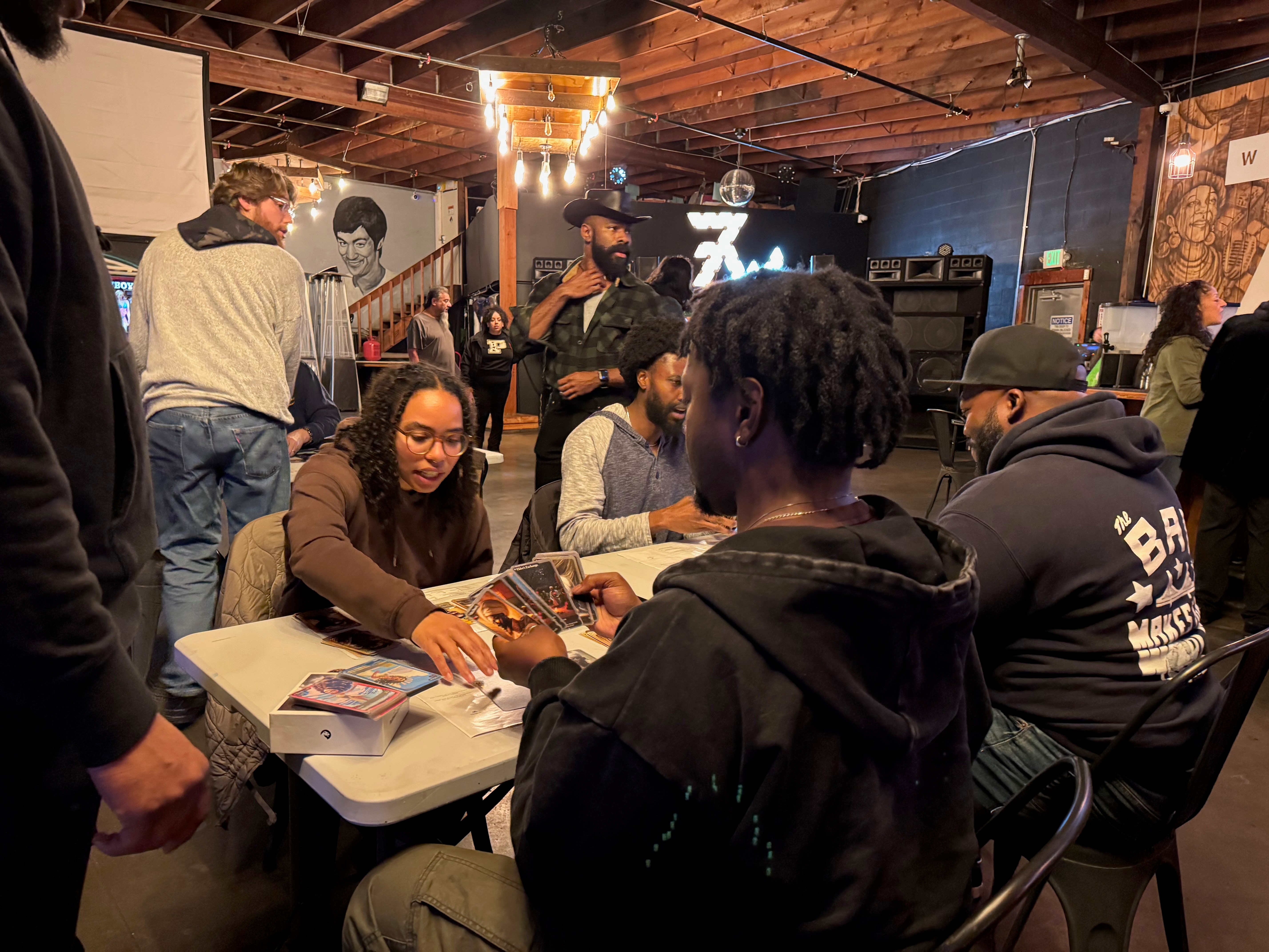Community members gather at a weekly game night in Oakland, turning play into connection and local culture into shared experience.